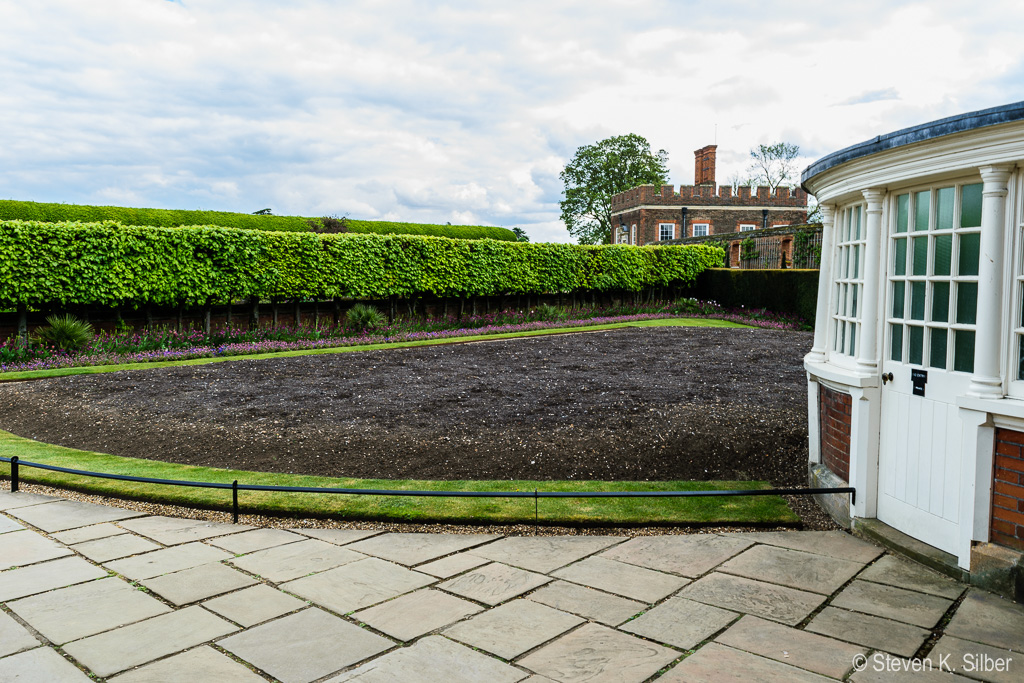 The root ball area for  watering and fertilizing the grape vine.  Planted in 1768, it now yields about 600 pounds of grapes per year. (1/30 sec at f / 11,  ISO 100,  18 mm, 18.0-55.0 mm f/3.5-5.6 ) April 28, 2017