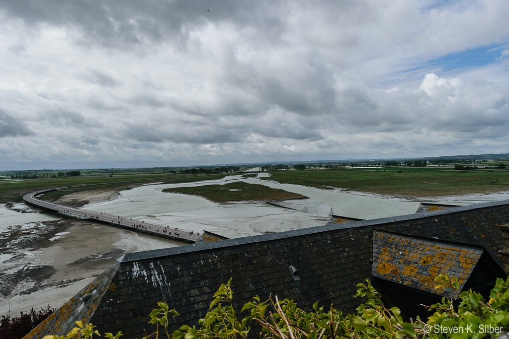 Bridge over the bay to give access to Mont St. Michel at low tide and the Couesnon River that feeds into the bay. (1/1250 sec at f / 6.3,  ISO 125,  18 mm, 18.0-55.0 mm f/3.5-5.6 ) May 12, 2017