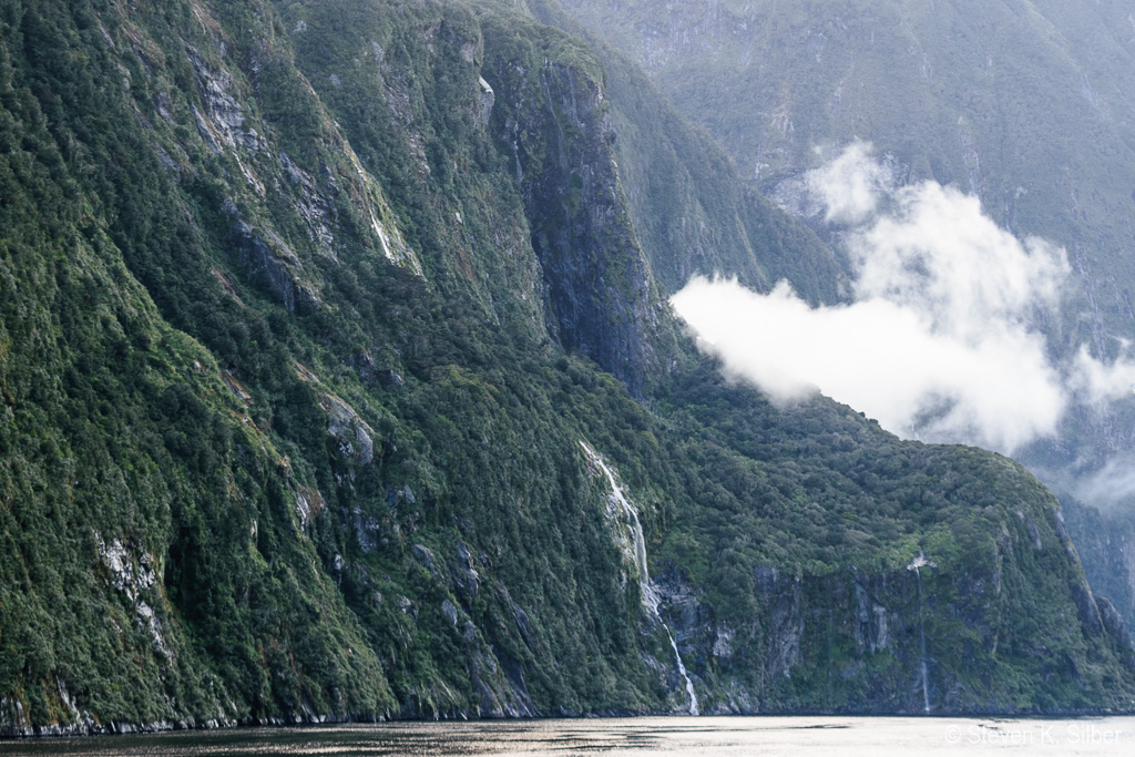 Water fall, one of many.  Fiordland receives about 9 feet of rain annually. (1/100 sec at f / 7.1,  ISO 200,  55 mm, 18.0-55.0 mm f/3.5-5.6 ) November 18, 2023