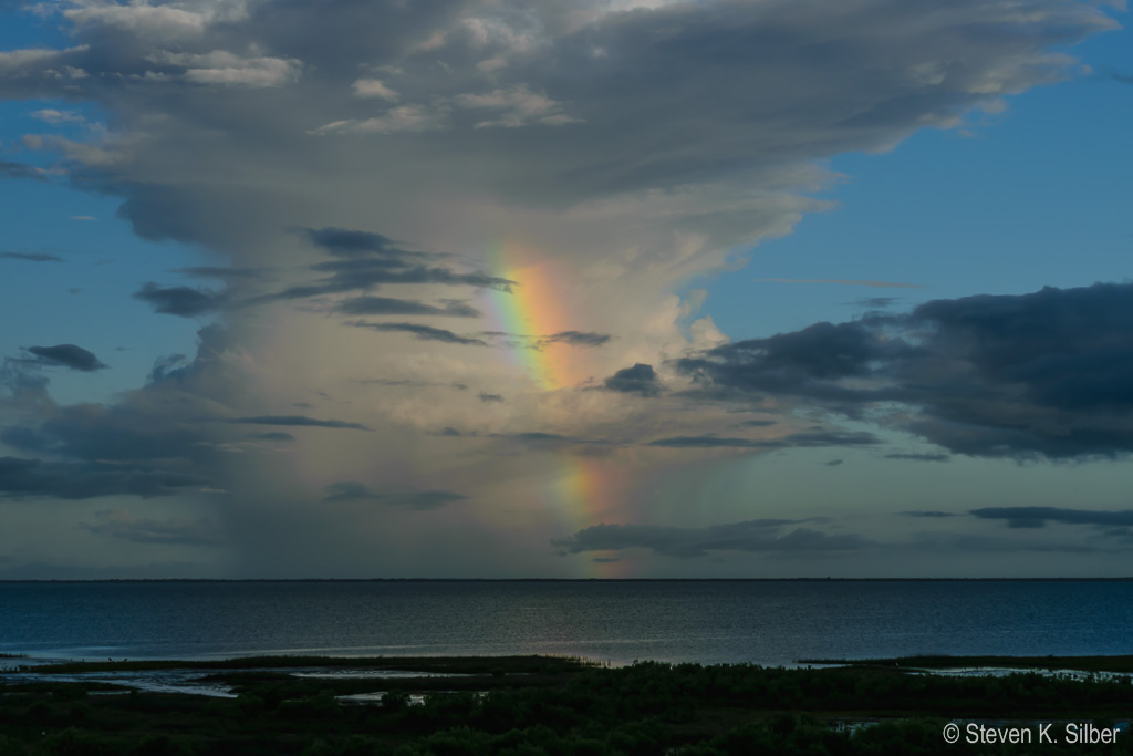 A morning rainbow against distant clouds. (1/100 sec at f / 14,  ISO 140,  55 mm, 18.0-55.0 mm f/3.5-5.6 ) June 28, 2017