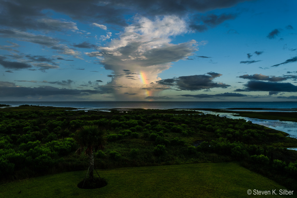 Only a portion of the rainbow is visible - clouds block the sun for part of it. (1/30 sec at f / 14,  ISO 100,  20 mm, 18.0-55.0 mm f/3.5-5.6 ) June 28, 2017
