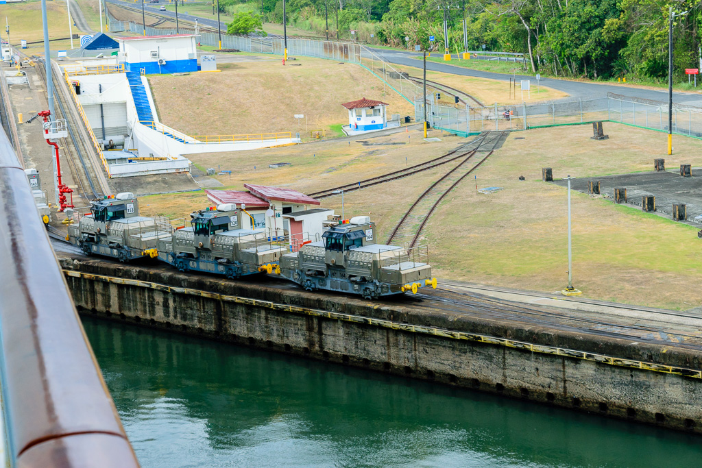 Approaching Gatun Locks.  Mules waiting to assist ships. (1/320 sec at f / 10,  ISO 400,  55 mm, 18.0-55.0 mm f/3.5-5.6 ) May 01, 2023